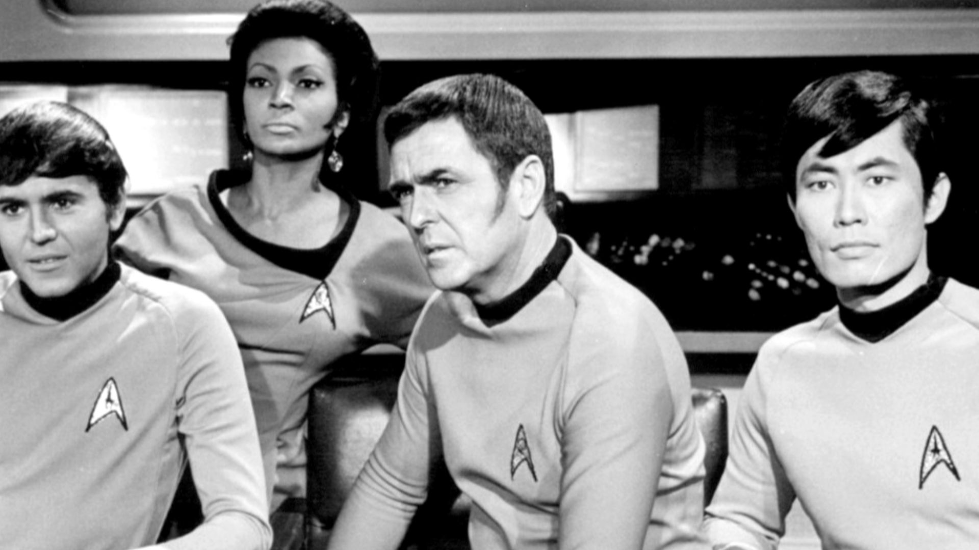 Photo of the crew of the Starship Enterprise from the television series Star Trek.  From left: Chekov (Walter Koenig), Uhura (Nichelle Nichols), Scott (James Doohan) and Sulu (George Takei).  They await the results of a battle which could mean the destruc