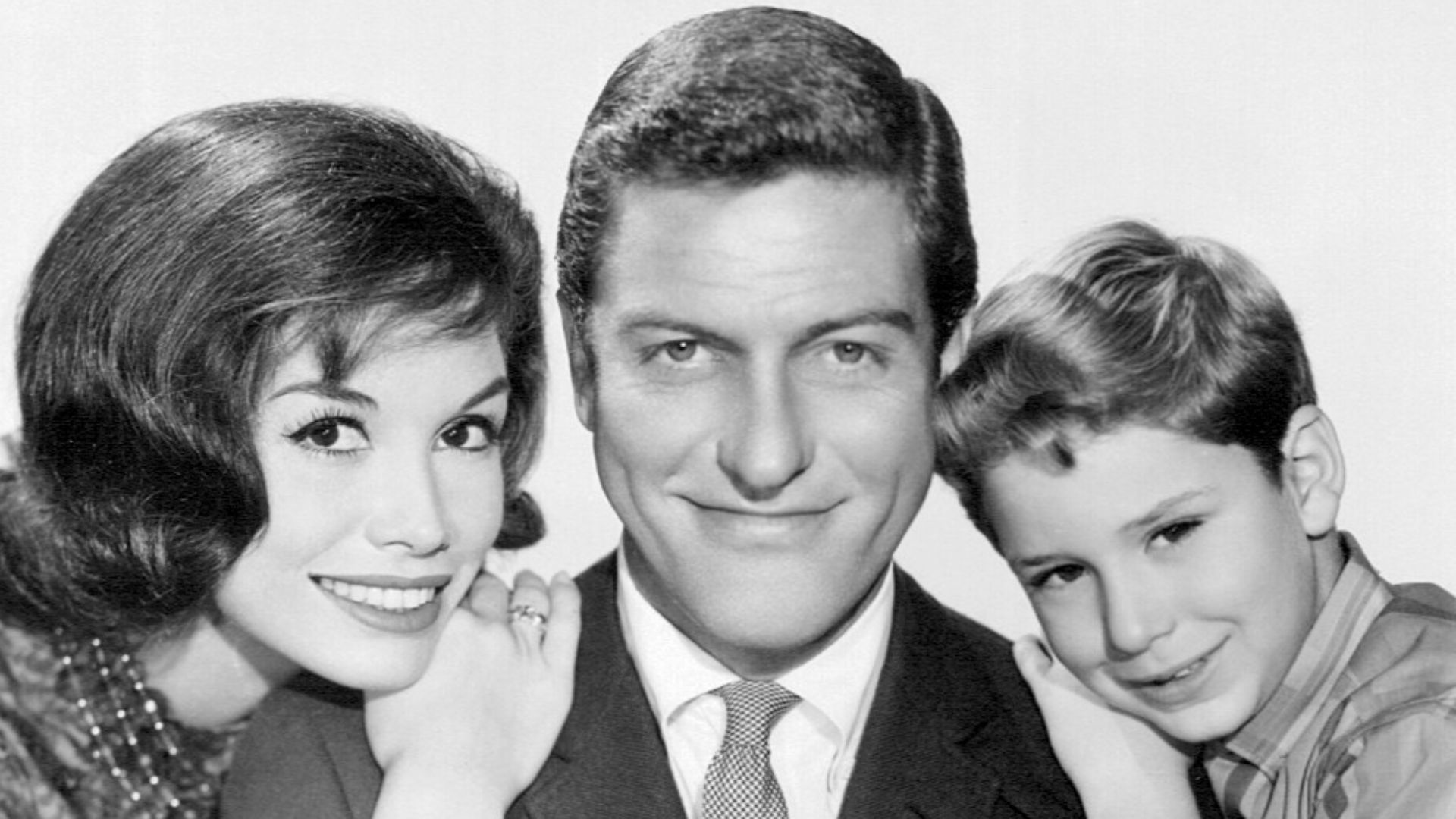 Photo of the Petrie family from the television program The Dick Van Dyke Show. From left-Mary Tyler Moore (Laura Petrie), Dick Van Dyke (Rob Petrie), Larry Mathews (Richie Petrie).