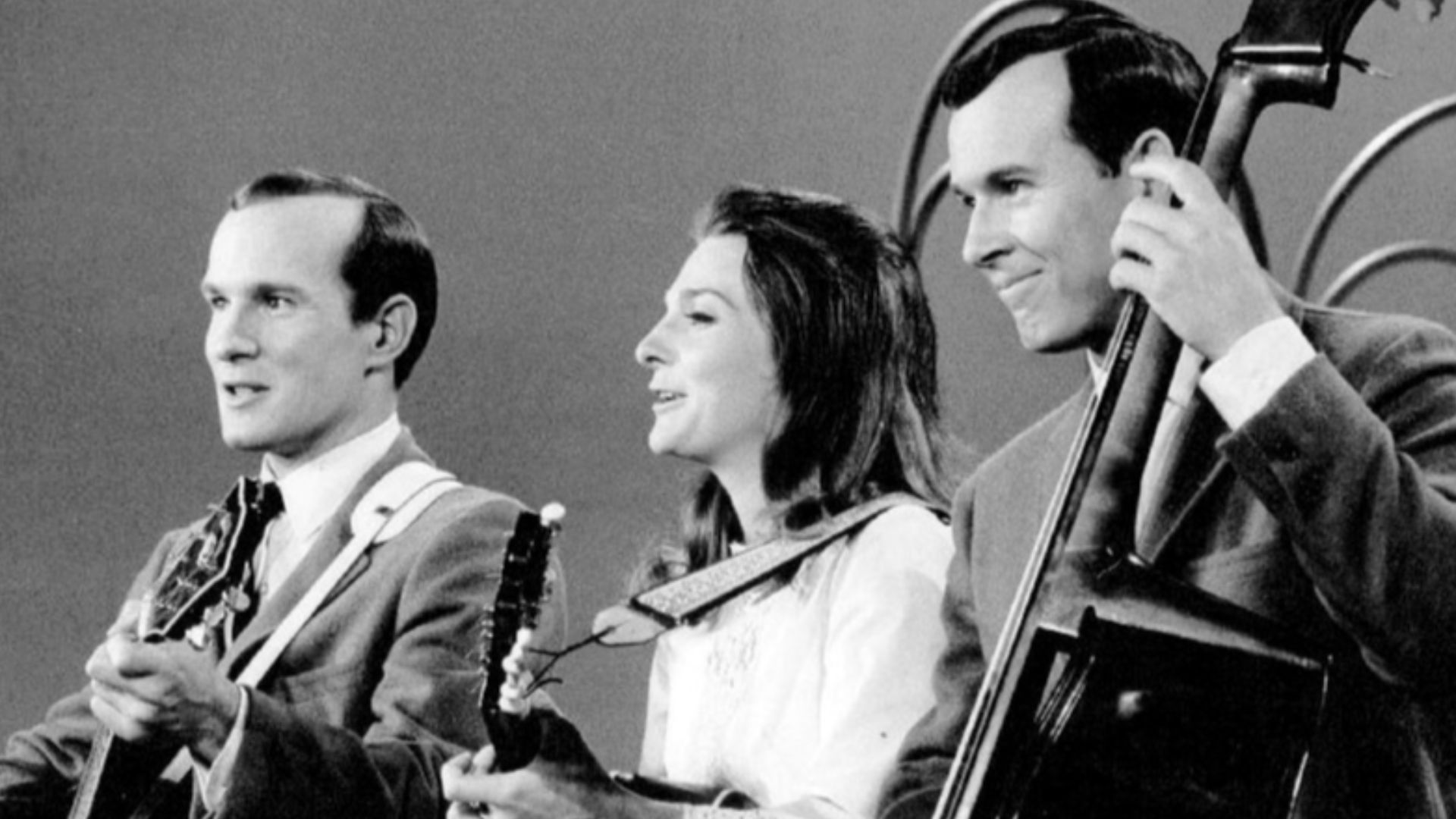Photo of Judy Collins performing with Tom (left) and Dick Smothers on their television program The Smothers Brothers Comedy Hour.