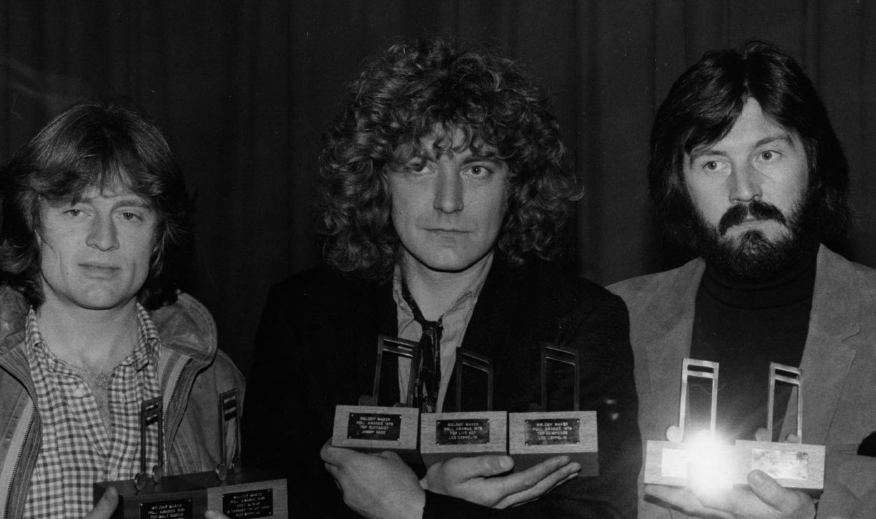 28th November 1979: Three members of rock group Led Zeppelin with their seven Melody Maker awards. They are, from left to right John Paul Jones (bass, keyboards), Robert Plant (vocals) and John Bonham (1947 - 1980) (drums).