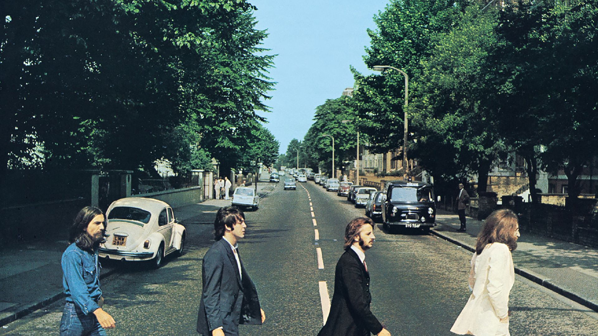 Front cover of Abbey Road by The Beatles. The view really is Abbey Road, London, NW8 looking north.  The gates of the Abbey Road Studios are behind the white VW Beetle on the left.