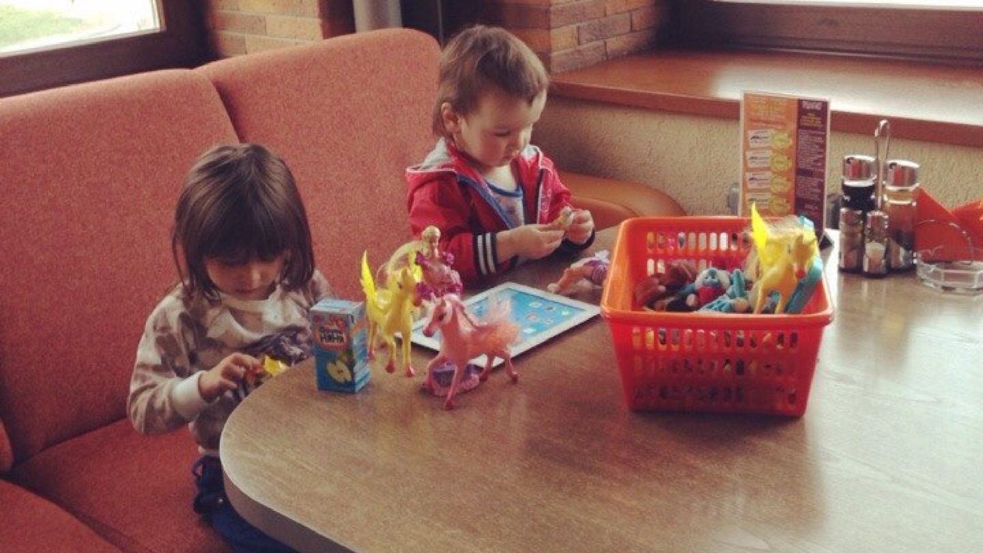 Two kids playing next to each other without interaction.
