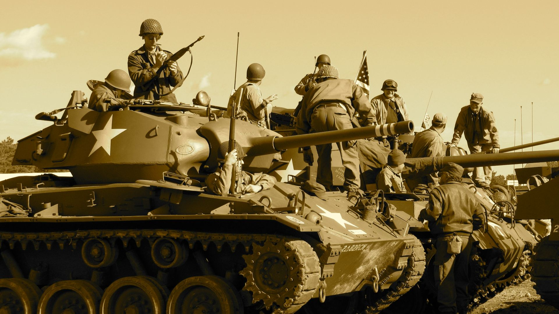 people sitting and standing on battle tank