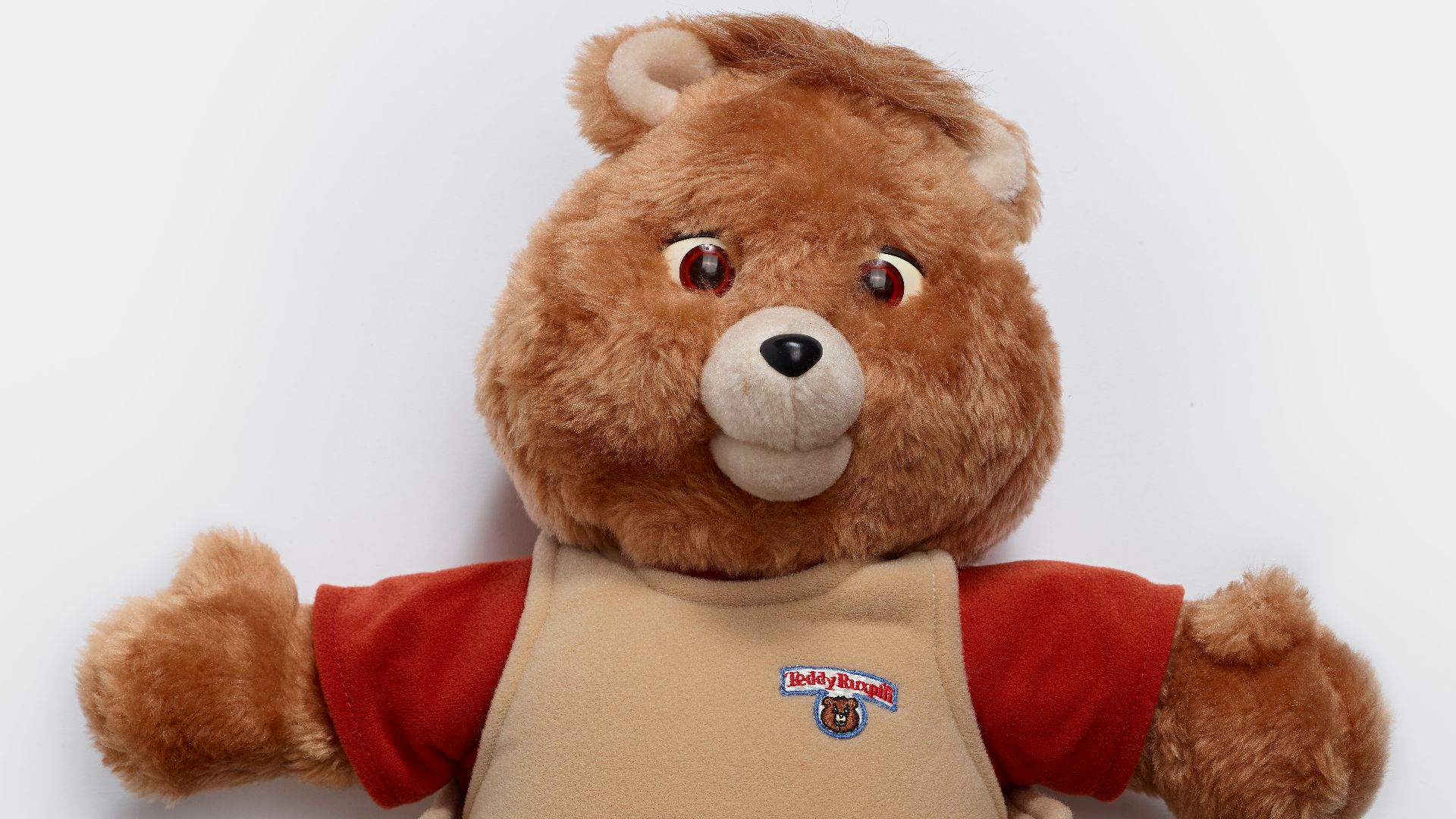 Teddy Ruxpin is an animatronic children's toy in the form of a talking 'Illiop', a creature that looks like a bear. The bear's mouth and eyes move while