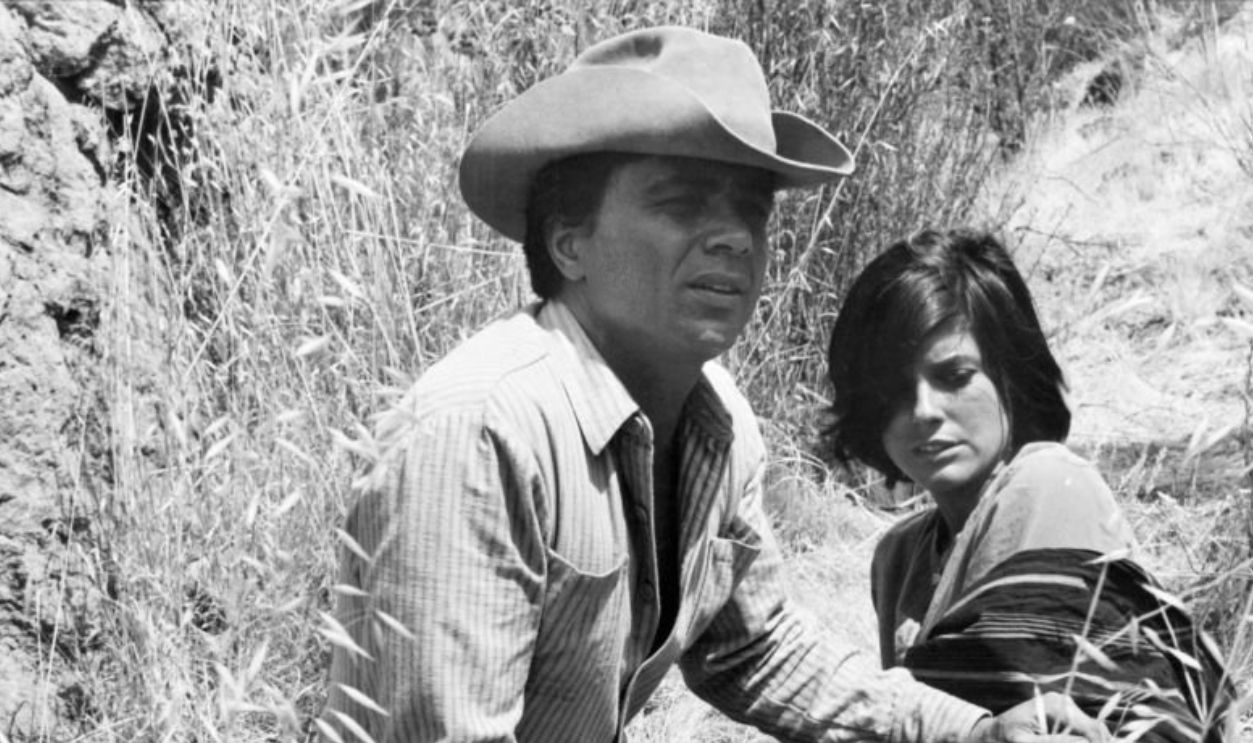 Robert Blake sits on the ground with Katharine Ross in a scene from the film 'Tell Them Willie Boy Is Here', 1969.