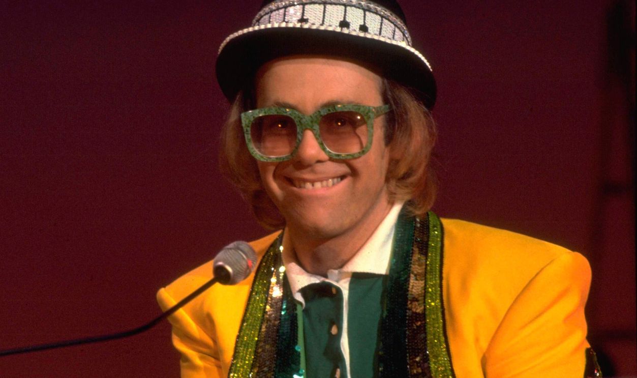 English pop/rock musician Elton John performing his song 'Goodbye Yellow Brick Road' on the set of The Muppet Show at Elstree Studios, Hertfordshire, circa October 1977.