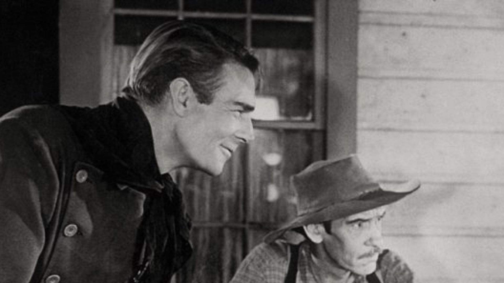 Screenshot of scene from the 1946 Western Abilene Town with actors (from left) Randolph Scott, Guy Wilkerson, and Edgar Buchanan. In this image Wilkerson, in an uncredited role, is playing the card game