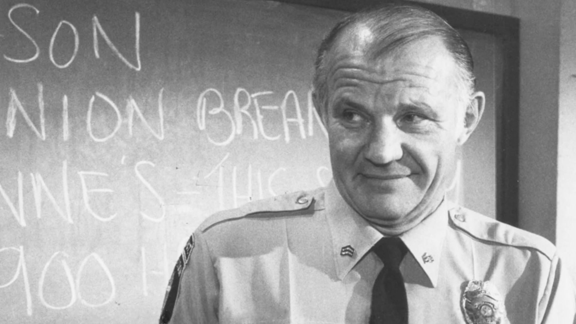 ESTERHAUS OF HILL STREET - Sergeant Esterhaus, Micheal Conrad reverently holds the urn containing ashes of the recently deceased telephone repairman at the station, in