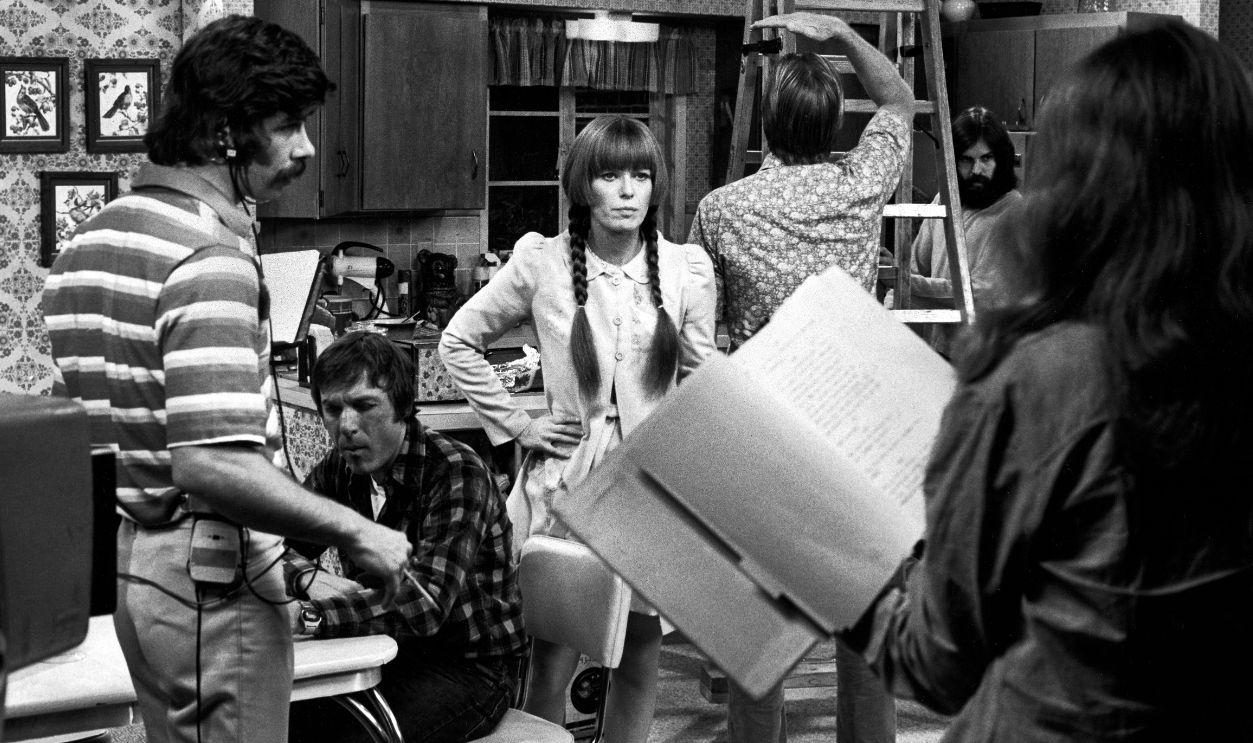 Production crew surrounding series star Louise Las