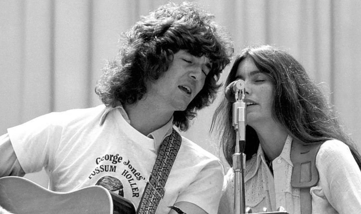 BERKELEY, CA - AUGUST 1975: Rodney Crowell and Emmylou Harris perform with the Hot Band at the Greek Theater on August 16, 1975 in Berkeley, California.