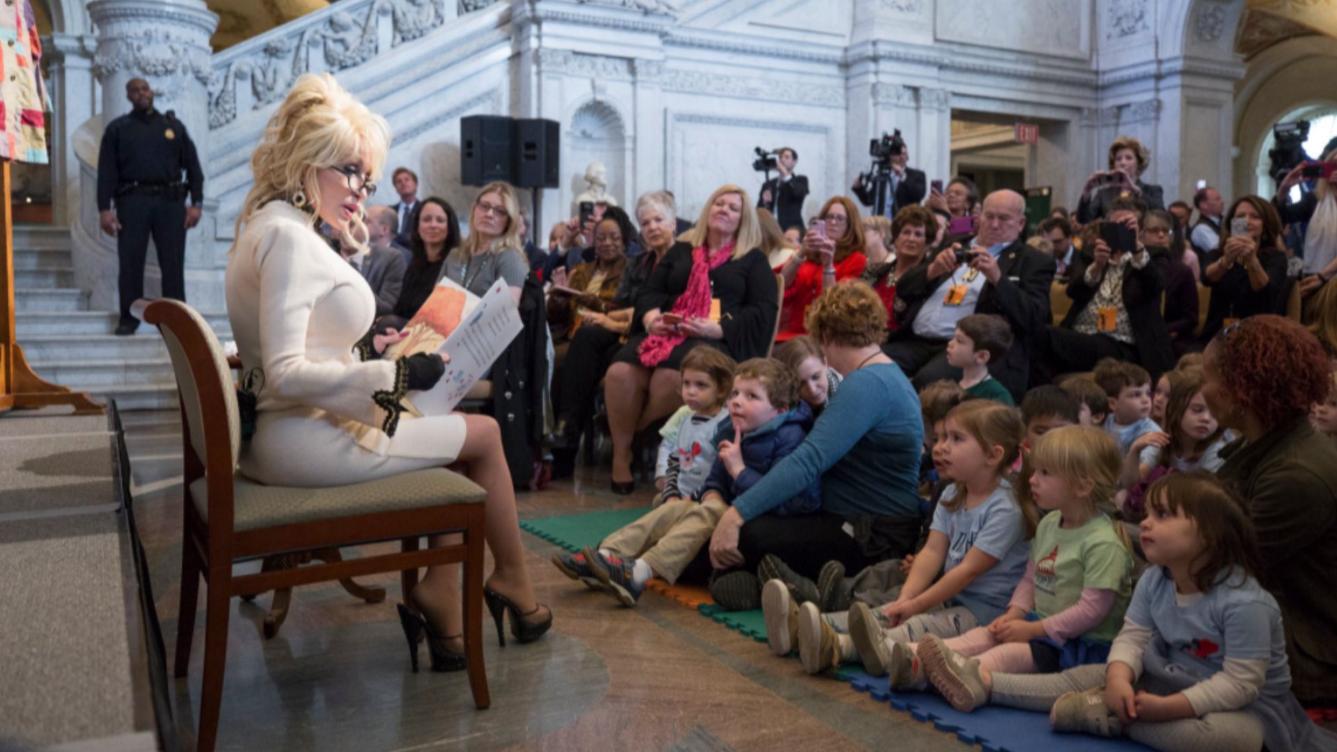 Dolly Parton reads to children in the Library of Congress Great Hall in 2018.