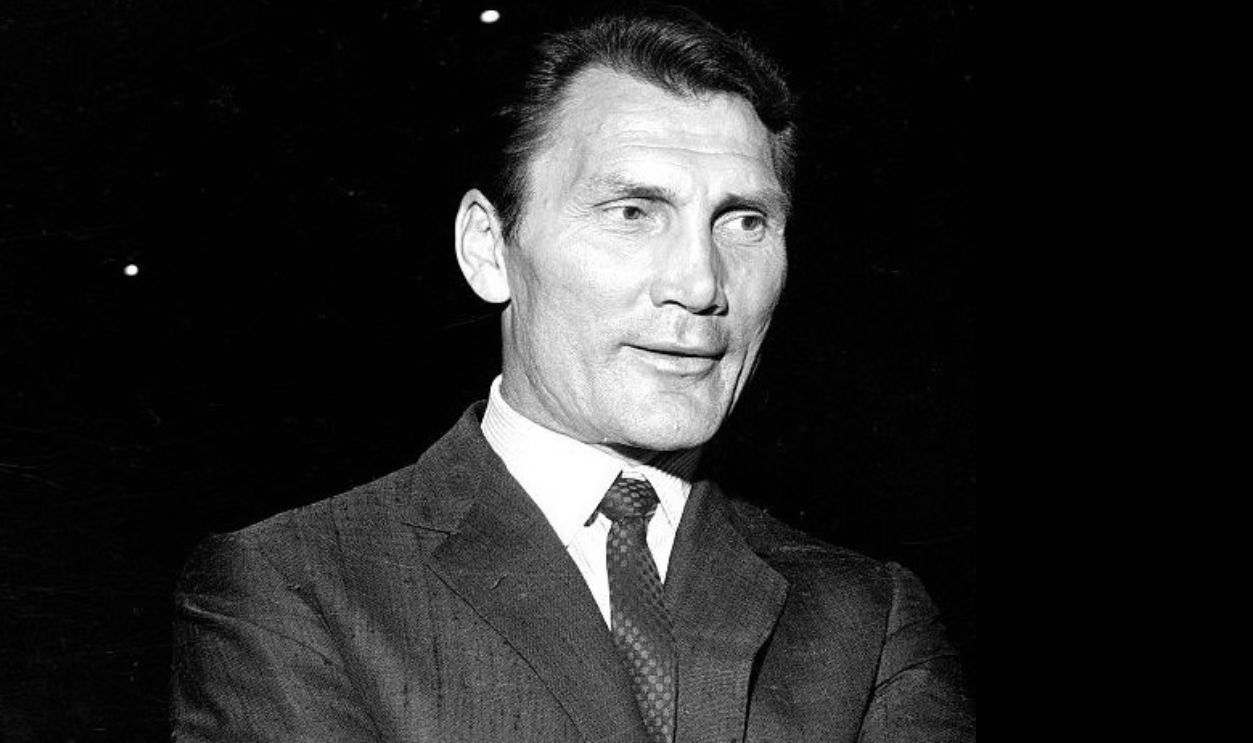 Getty Images - 524217909 - Jack Palance wearing a suit and looking in the distance.