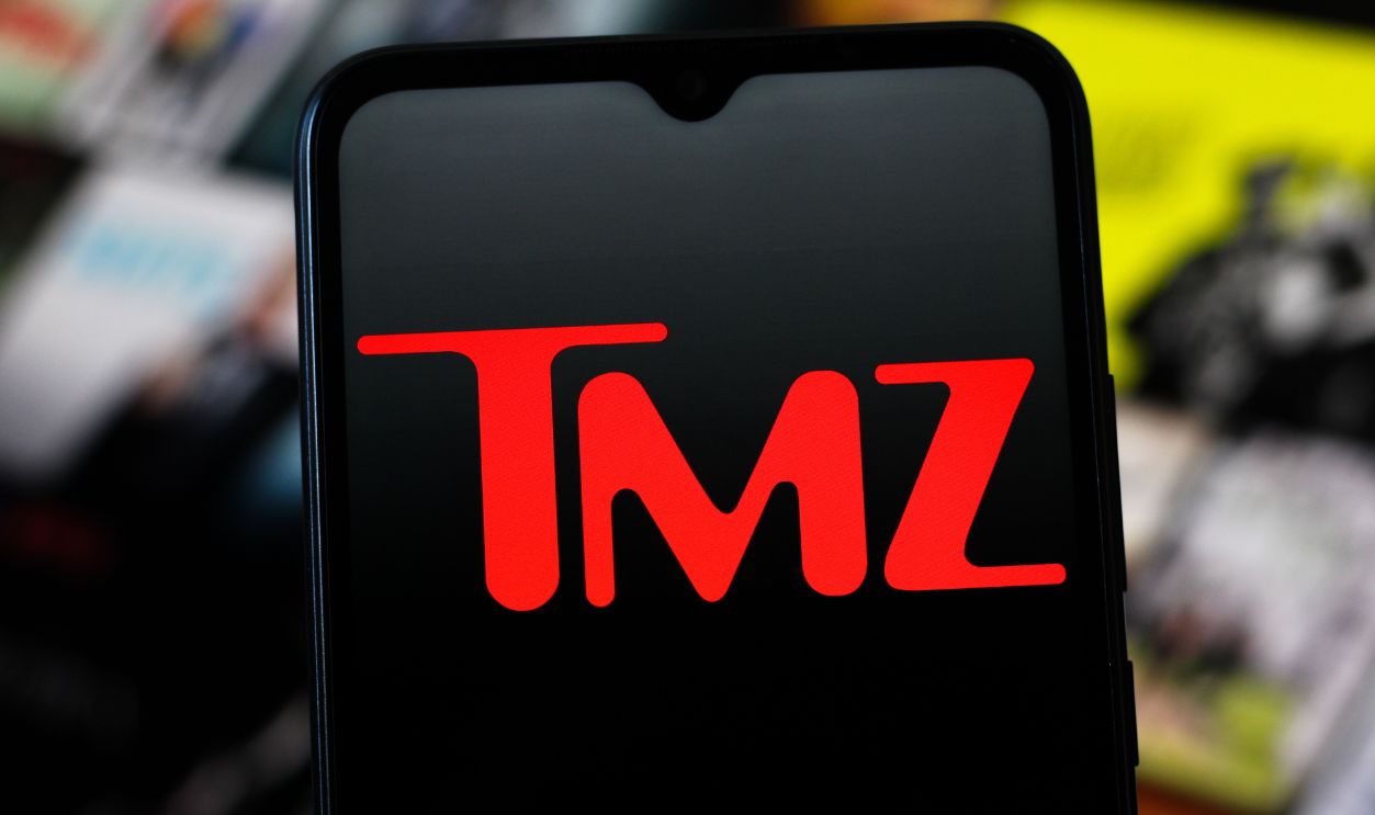 Getty Images - 2247902254 - In this photo illustration, the TMZ logo is seen displayed on a smartphone screen. 