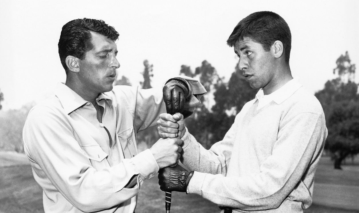 Dean Martin appears to get the best of Jerry Lewis with his hand grabbing the top of the golf club, California, 1953. 