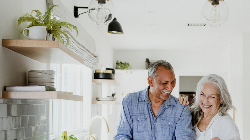 Elderly couple cooking in a kitchen