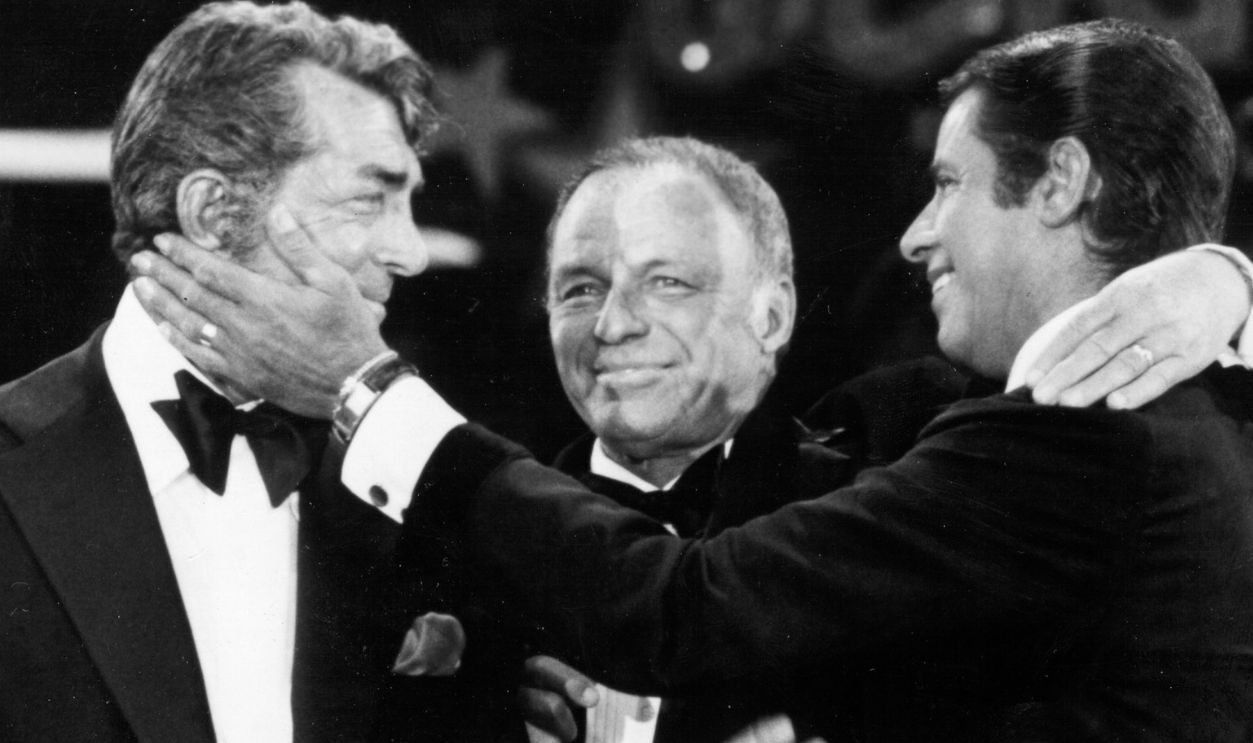 (L to R) Singers Dean Martin, Frank Sinatra and Jerry Lewis perform during the 1976 telecast of The Jerry Lewis MDA Telethon in Los Angeles, California. This Labor Day marks the 37th year for the telethon that aids those affected by neuromuscular diseases.