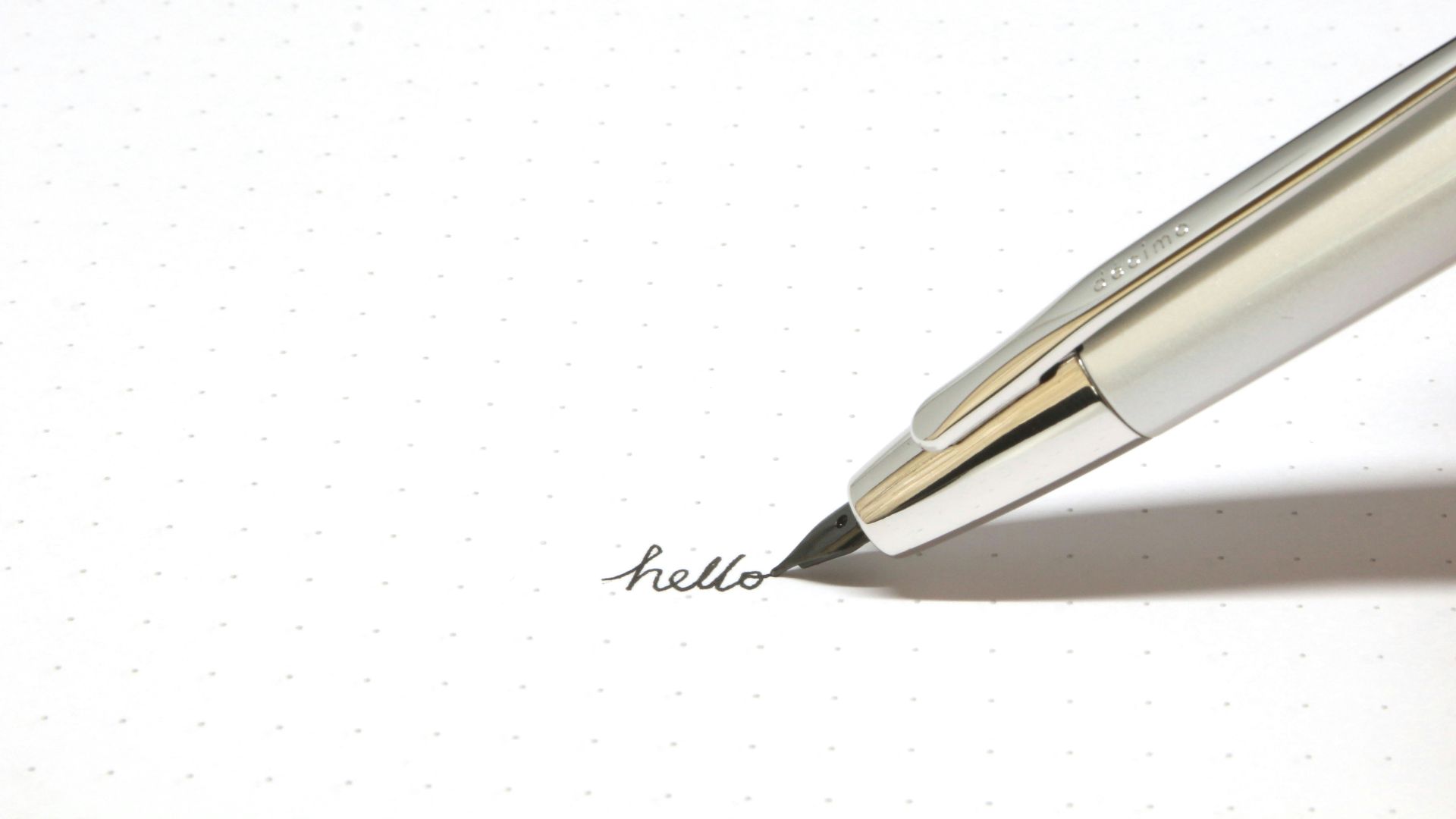 silver click pen on white paper