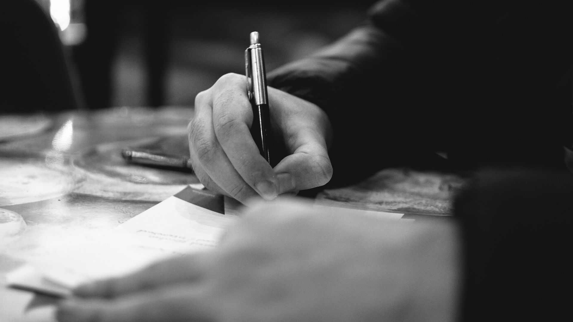 person writing on white paper