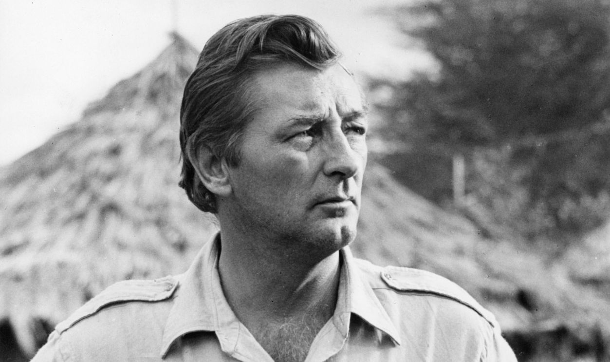 Robert Mitchum with hands at hips in a scene from the film 'Mister Moses', 1965.