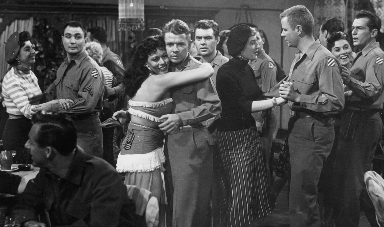 Getty Images - 143925374 - Audie Murphy, Paul Picerni, Jack Kelly, and Marshall Thompson at party dancing with women in a scene from the film 'To Hell And Back', 1955.