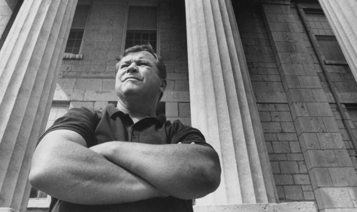 Ex-actor/self-proclaimed pres. cand. Tom Laughlin posing on the front steps of the old state capitol bldg. during his campaign tour of the state.