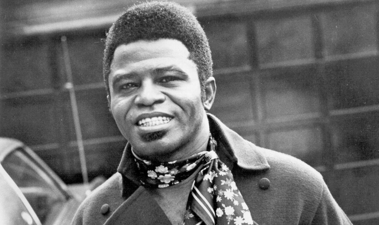 'Godfather of Soul' James Brown poses for a portrait wearing a scarf in circa 1965. 
