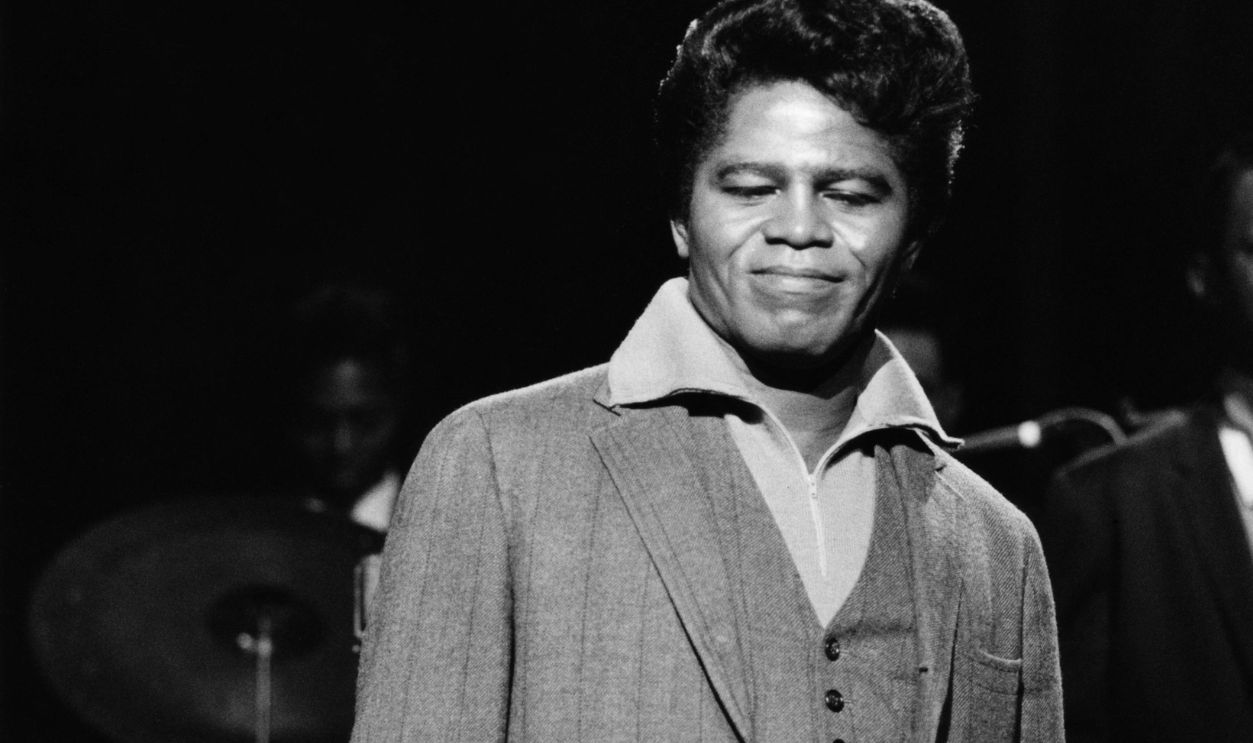 American soul singer and songwriter James Brown (1933-2006) performs live on stage with The Famous Flames, including saxophonist St. Clair Pinckney (1930-1999) behind, on the set of the Associated Rediffusion Television pop music television show Ready Steady Go! at Wembley Television Studios in London on 11th March 1966. David Redfern Premium Collection.