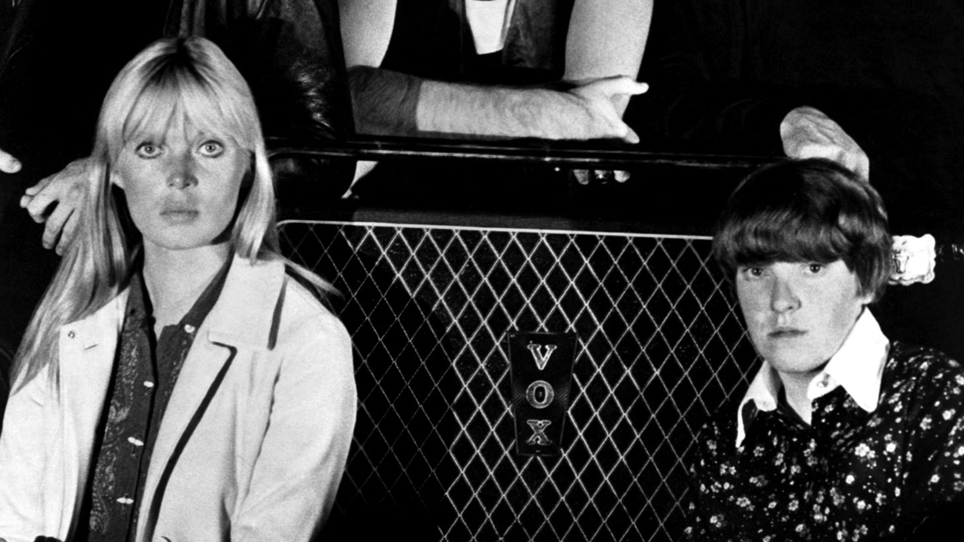 A publicity photo of the American rock band The Velvet Underground circa 1966, around the time that they were recording their debut album The Velvet Underground & Nico. The band members are positioned around a Vox-brand amplifier. Clockwise from top left: Lou Reed, Sterling Morrison, John Cale, Maureen Tucker, and Nico.