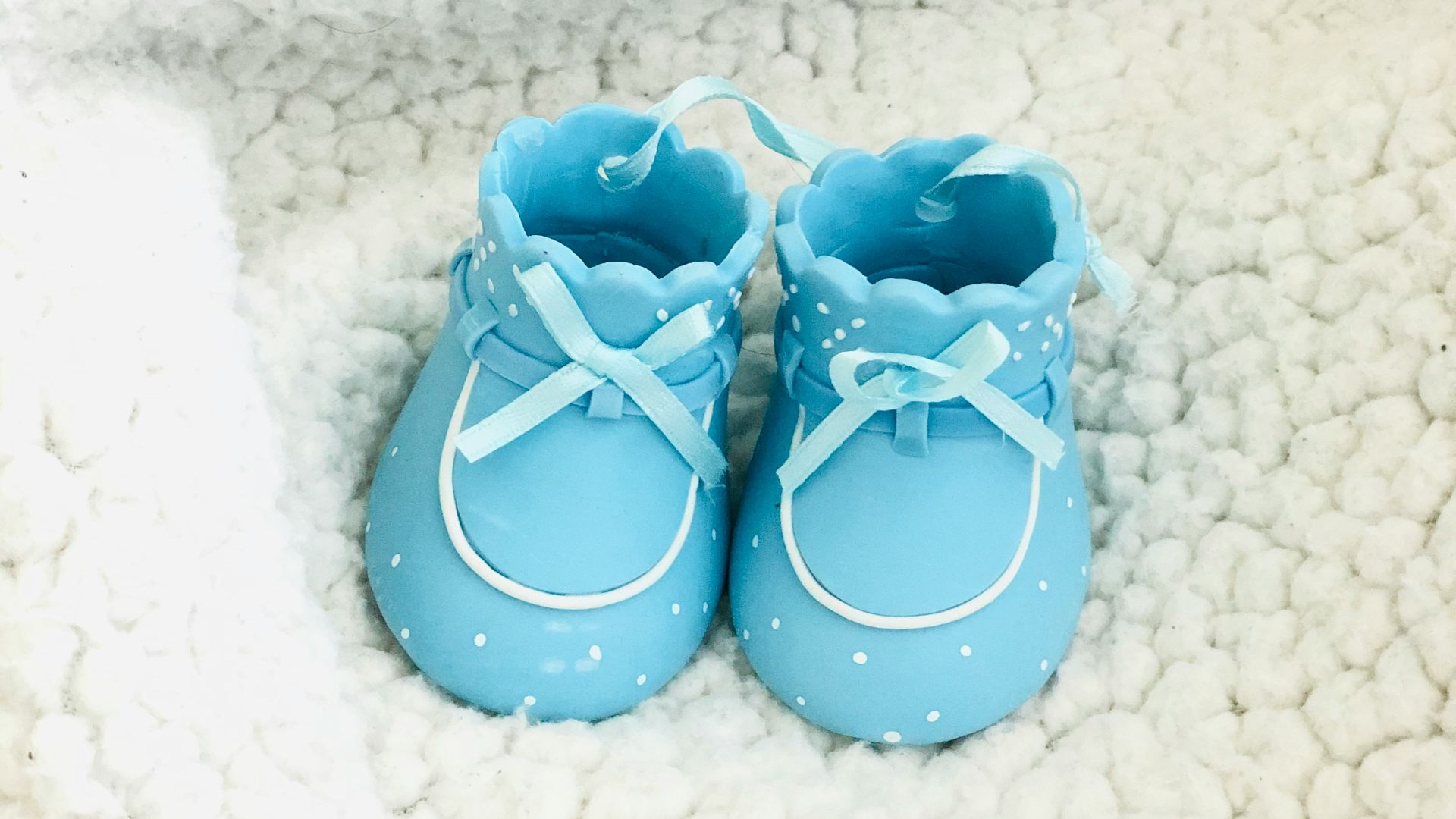 red and white polka dot flip flops on white textile
