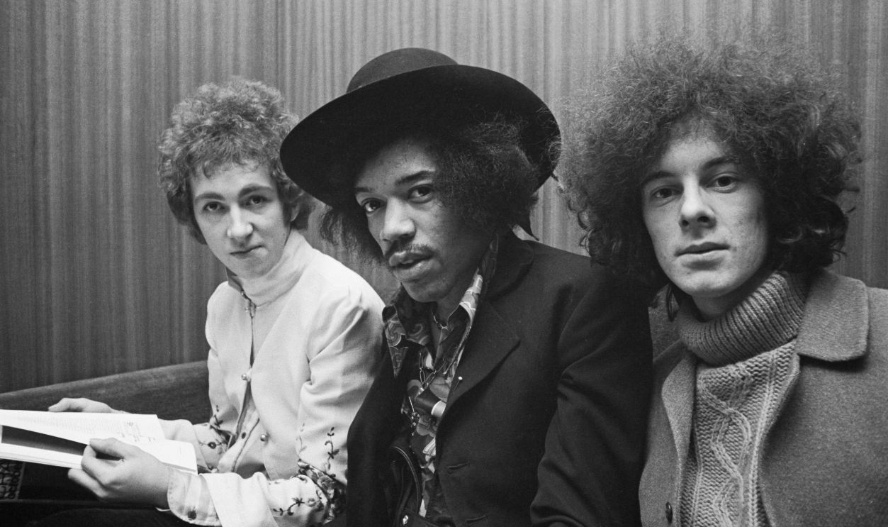 The Jimi Hendrix Experience American guitarist and singer Jimi Hendrix (1942-1970) seated in centre with, on left, drummer Mitch Mitchell (1946-2008) and, on right, bassist Noel Redding (1945-2003) of the Jimi Hendrix Experience in London, circa August 1967.