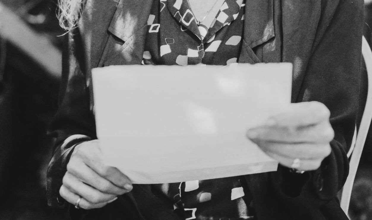 An Elderly Woman Wearing Eyeglasses while Holding a Letter
