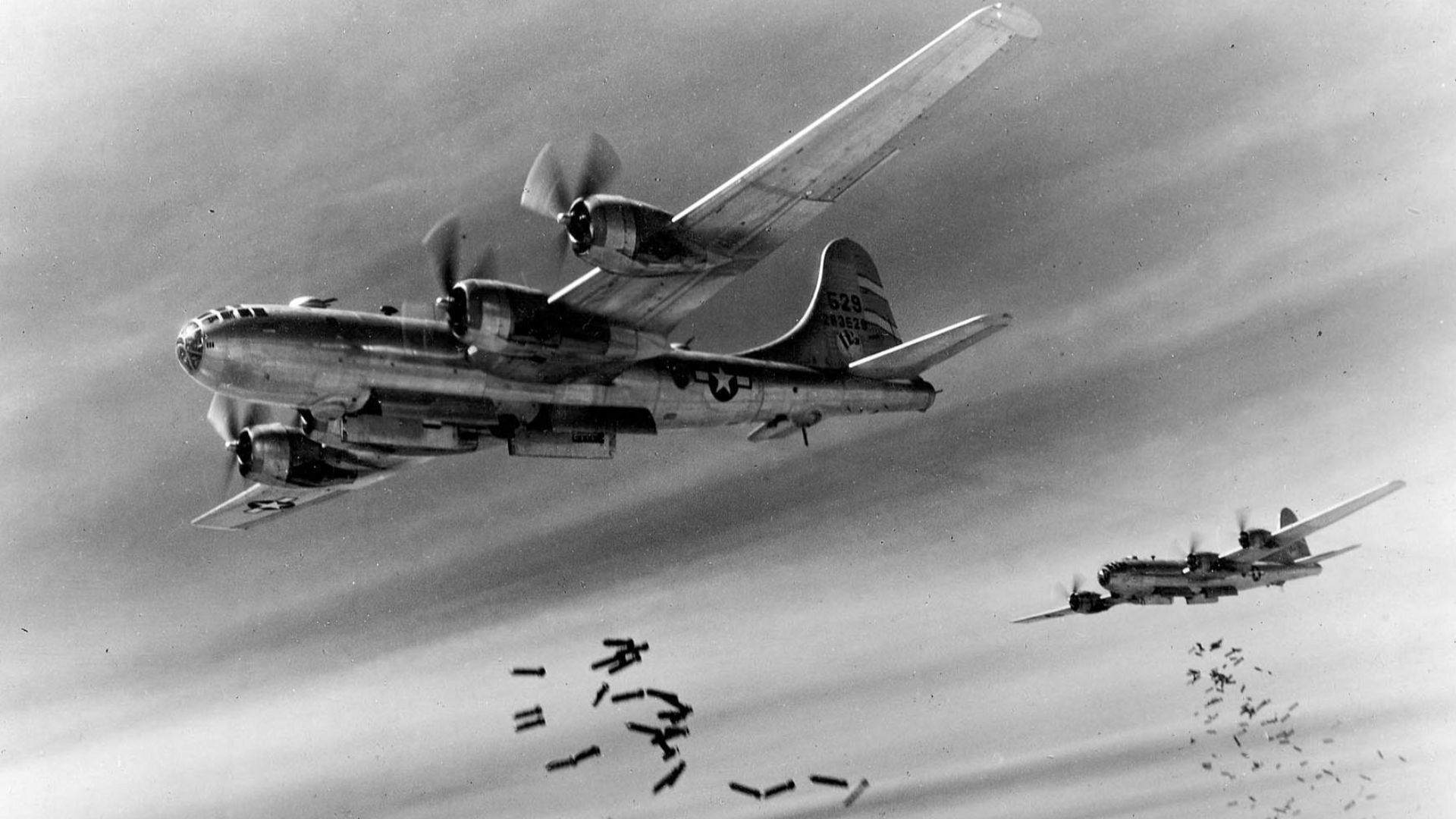 Boeing B-29s drop bombs over Rangoon, Burma. Nearest aircraft is B-29-25-BA (S/N 42-63526) of the 871st Bomb Squadron, 497th Bomb Group, 20th Air Force. This aircraft was reported as shot down by flak Mar 24, 1945 near Nagoya, Japan
 (U.S. Air Force photo)
