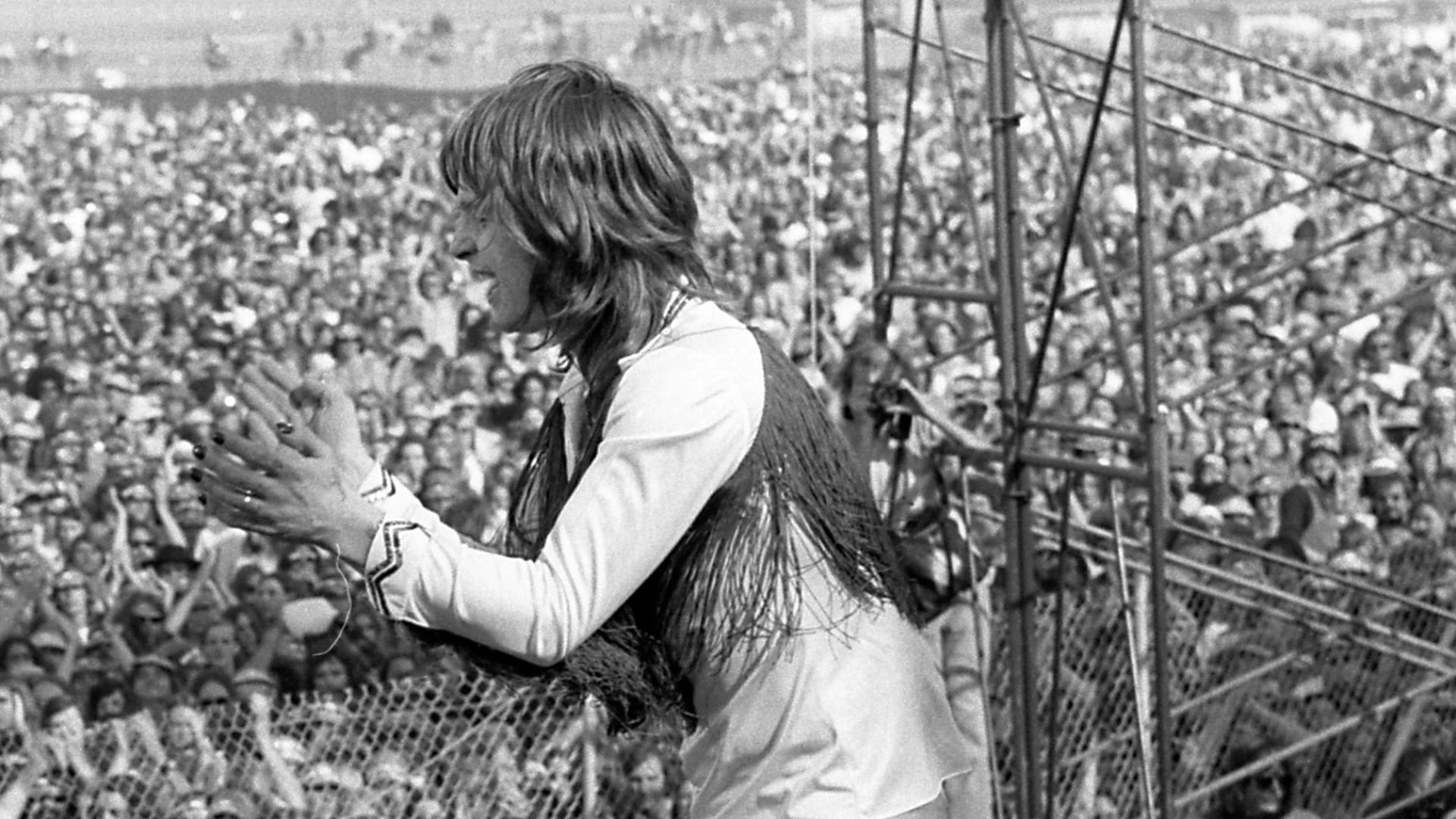 Ozzy Osbourne of Black Sabbath performing before crowd at California Jam concert in Ontario, California