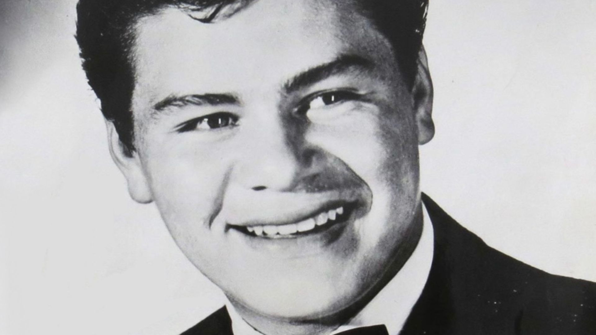 Ritchie Valens in a press photo dated to 1959. No copyright markings on the photo. The signature reads,