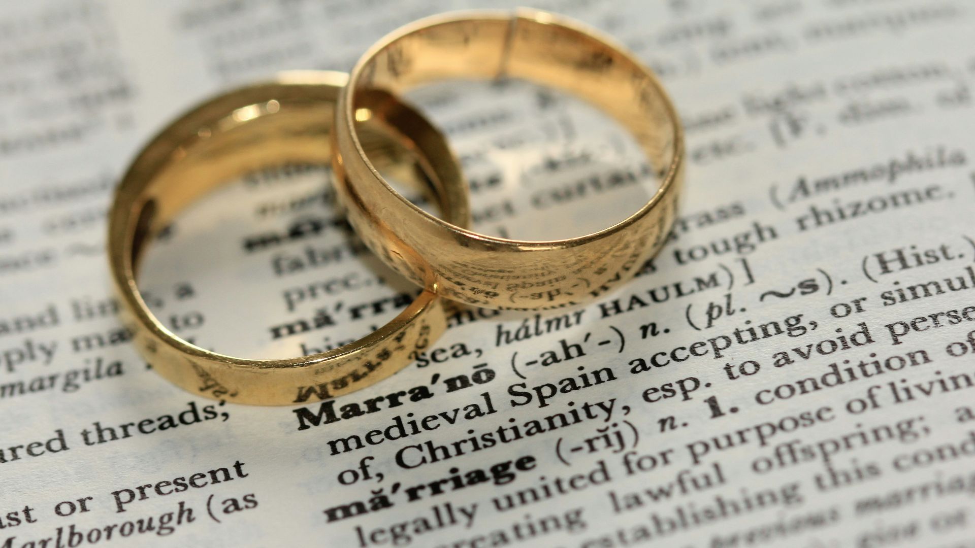 two gold-colored rings on paper
