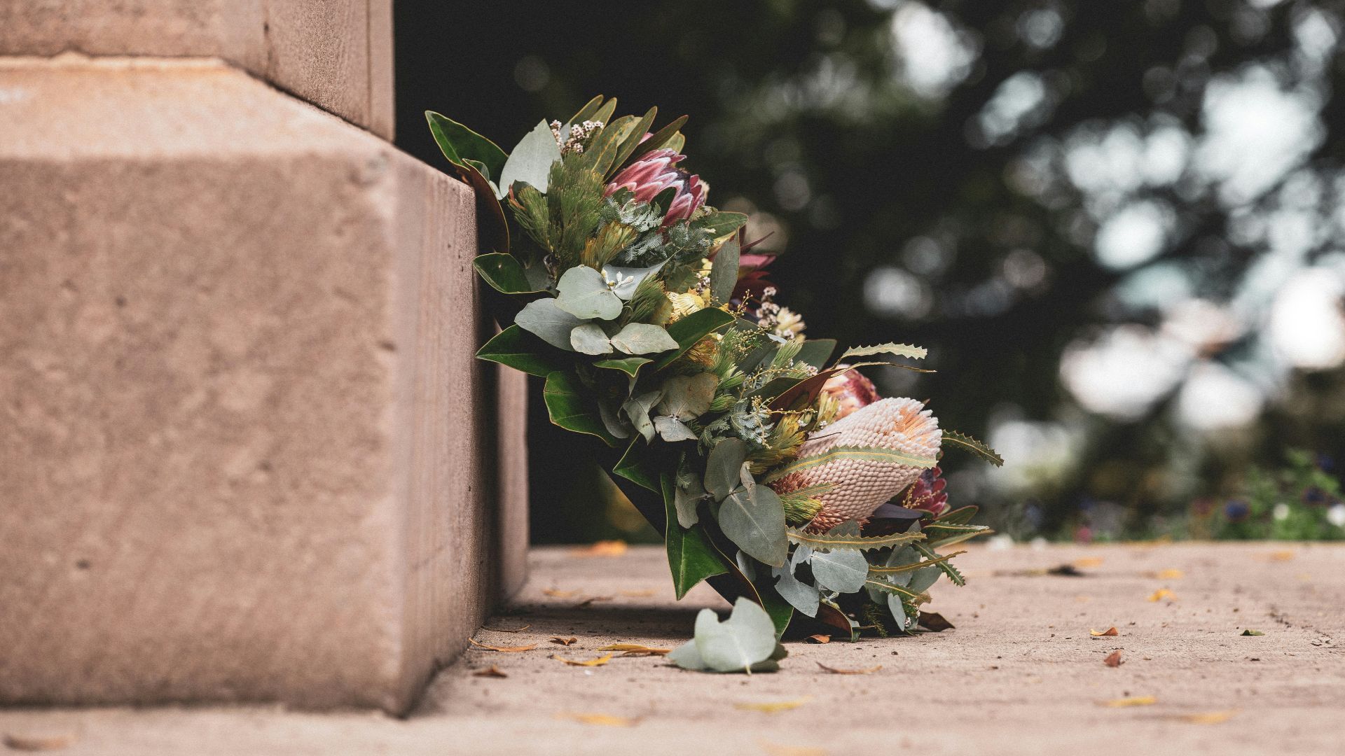 pink and green flower bouquet on brown concrete wall