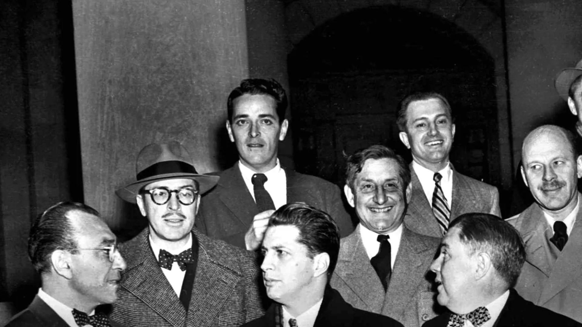 Ten Hollywood personalities, the “Hollywood 10,” stand with their attorneys outside district court in Washington, D.C., Jan. 9, 1948 before arraignment on contempt of Congress charges. From left, front: Herbert Biberman, Attorney Martin Popper, Attorney Robert W. Kenny, Albert Maltz and Lester Cole. Second row, from left: Dalton Trumbo, John Howard Lawson, Alvah Bessie and Samuel Ornitz. Top row, from left: Ring Lardner Jr., Edward Dmytryk and Adrian Scott. The ten were charged for refusing to cooperate with the House Un-American Activities Committee.