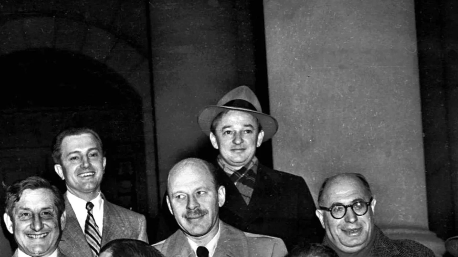 Ten Hollywood personalities, the “Hollywood 10,” stand with their attorneys outside district court in Washington, D.C., Jan. 9, 1948 before arraignment on contempt of Congress charges. From left, front: Herbert Biberman, Attorney Martin Popper, Attorney Robert W. Kenny, Albert Maltz and Lester Cole. Second row, from left: Dalton Trumbo, John Howard Lawson, Alvah Bessie and Samuel Ornitz. Top row, from left: Ring Lardner Jr., Edward Dmytryk and Adrian Scott. The ten were charged for refusing to cooperate with the House Un-American Activities Committee.