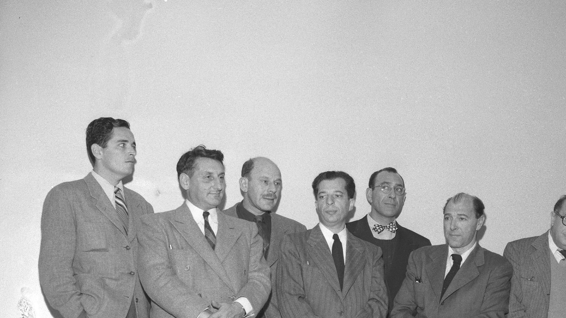 Charged with contempt of Congress, nine Hollywood men give themselves up to U.S. Marshal in December 10, 1947. 
From right: Robert Adrian Scott, Edward Dmytryk, Samuel Ornitz, Lester Cole, Herbert Biberman, Albert Maltz, Alvah Bessie, John Howard Lawson and Ring Lardner Jr.