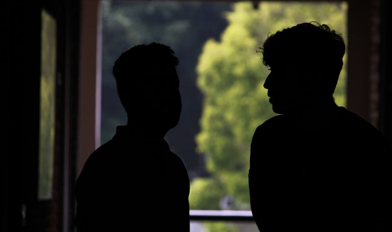 A couple of men standing next to each other