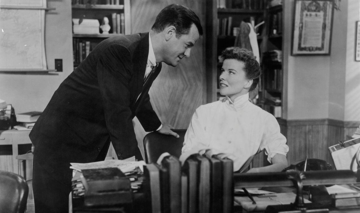Gig Young approaches Katharine Hepburn in a scene from the film 'Desk Set', 1957.