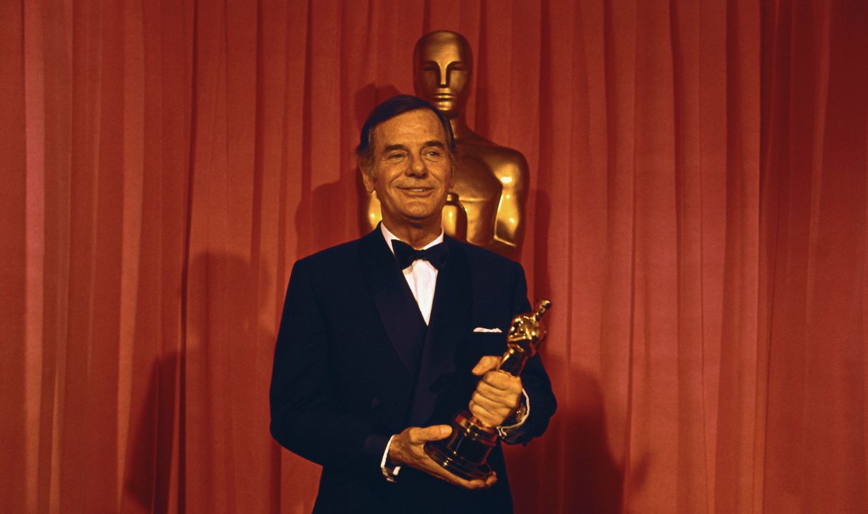 Gig Young holds Oscar he won for Best Supporting Actor, 1969, for