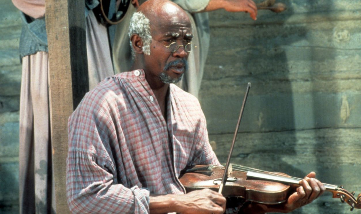Louis Gossett Jr holding violin in a scene from the Television Series 'Roots', 1977.