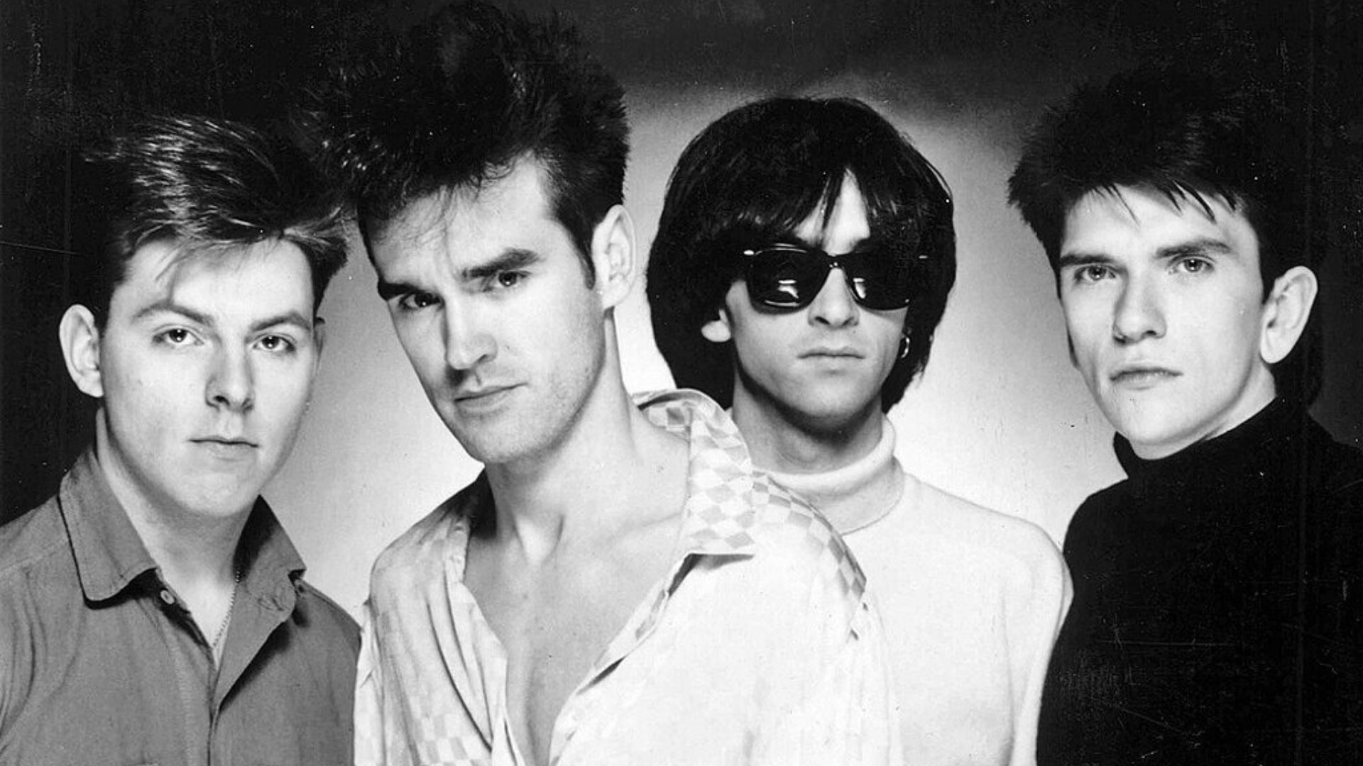 The Smiths in a promotional photograph for their debut album The Smiths, circa 1984. From left to right; Andy Rourke, Morrissey, Johnny Marr, and Mike Joyce. This photo was also issued later to promote their 1985 album Meat Is Murder.