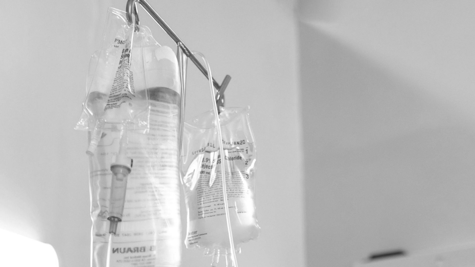 A patient receiving intravenous treatment in a hospital room, emphasizing healthcare and recovery.