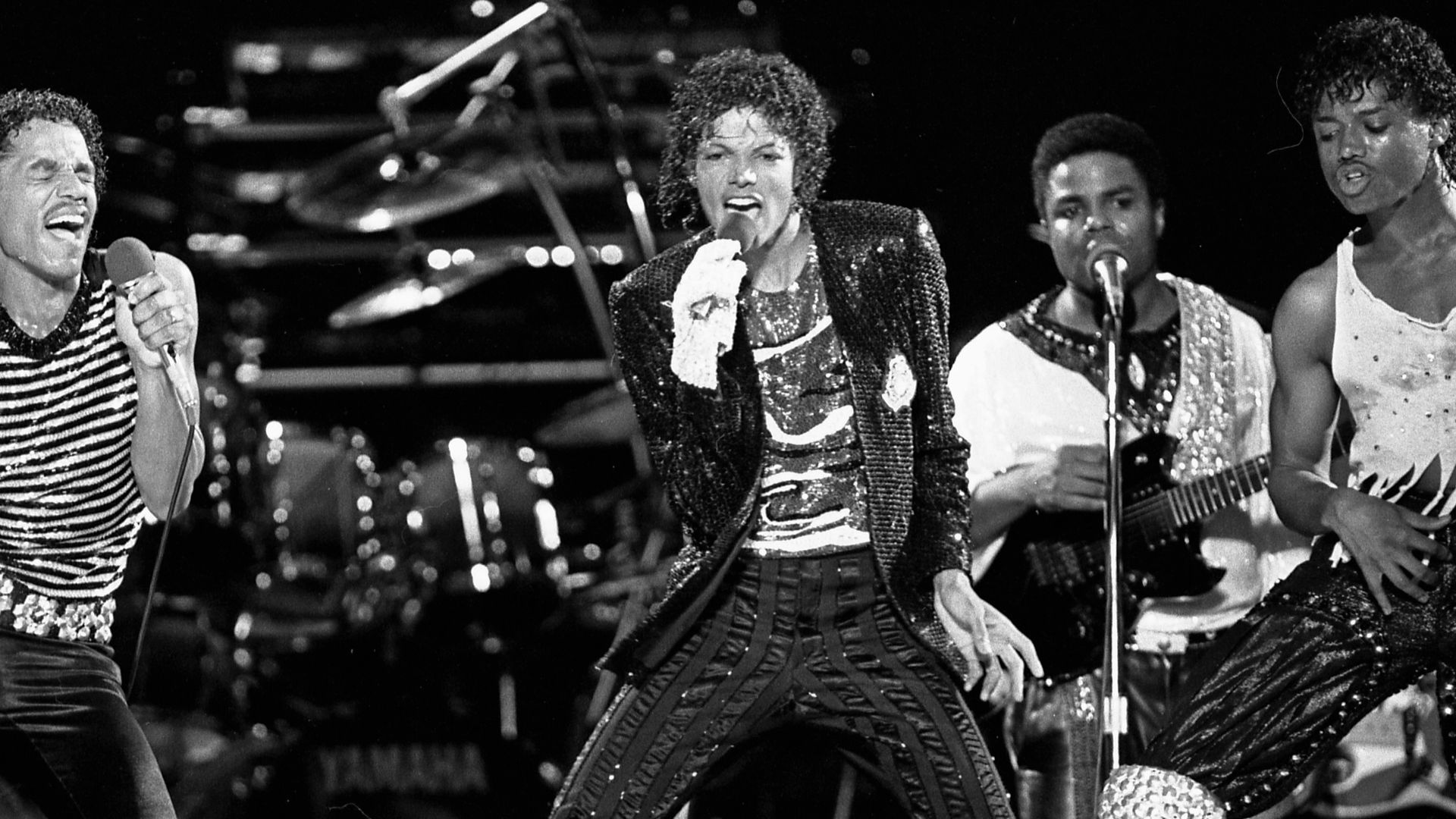 The Jacksons performing on stage at Arrowhead Stadium, Kansas City, during the Victory Tour