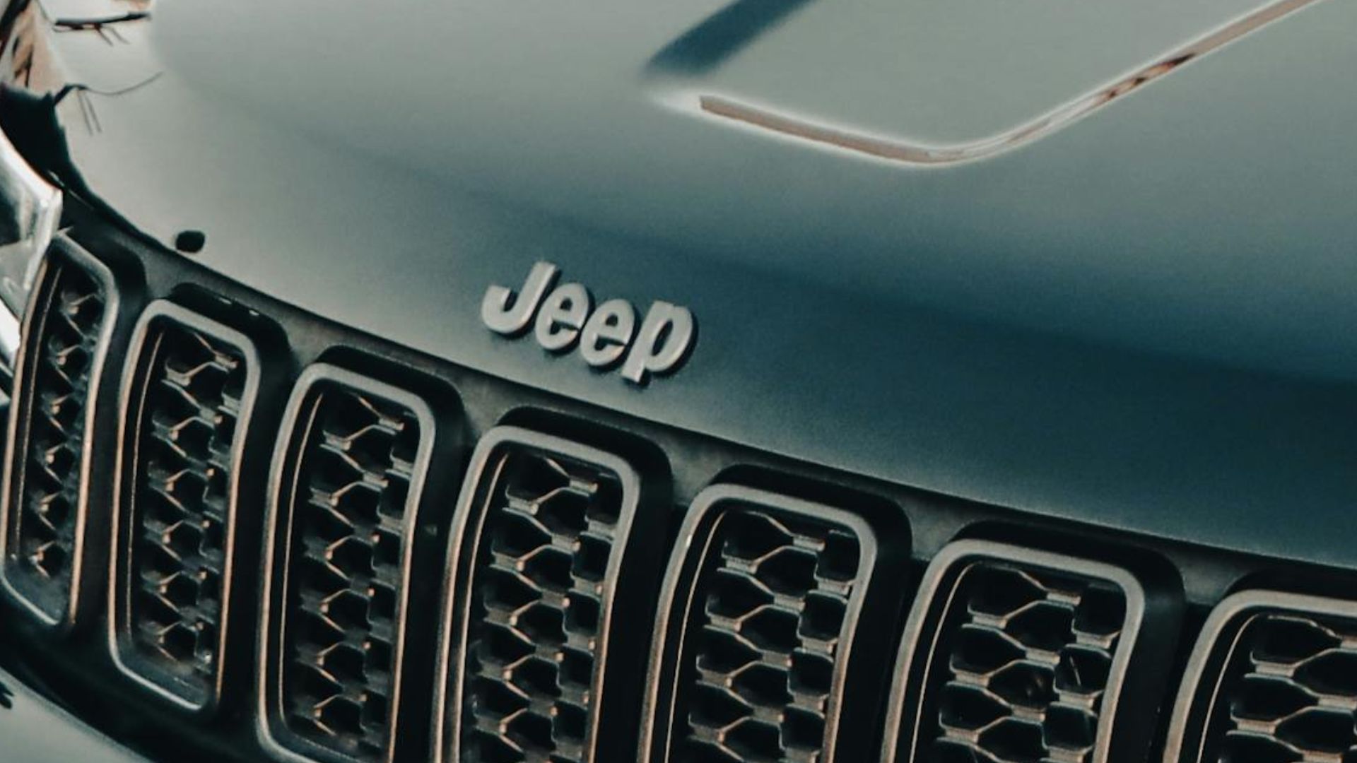 A shiny black Jeep parked outdoors in Erbil, Iraq. Captured in a modern urban environment.