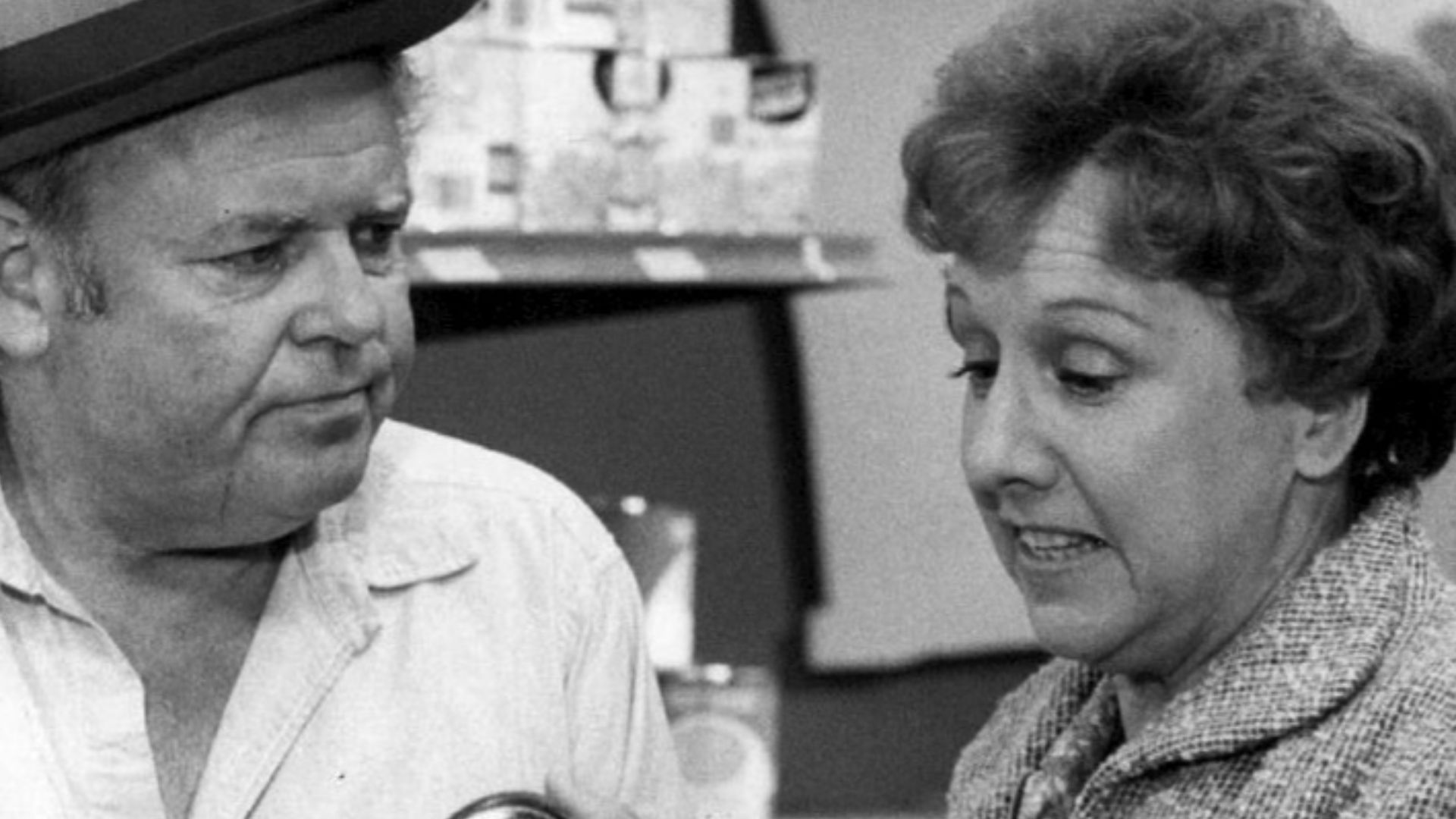 Photo of Carroll O'Connor and Jean Stapleton as Archie and Edith Bunker.  While on a layoff from the plant, Archie gets a lesson in the price of food when he accompanies Edith to the supermarket.