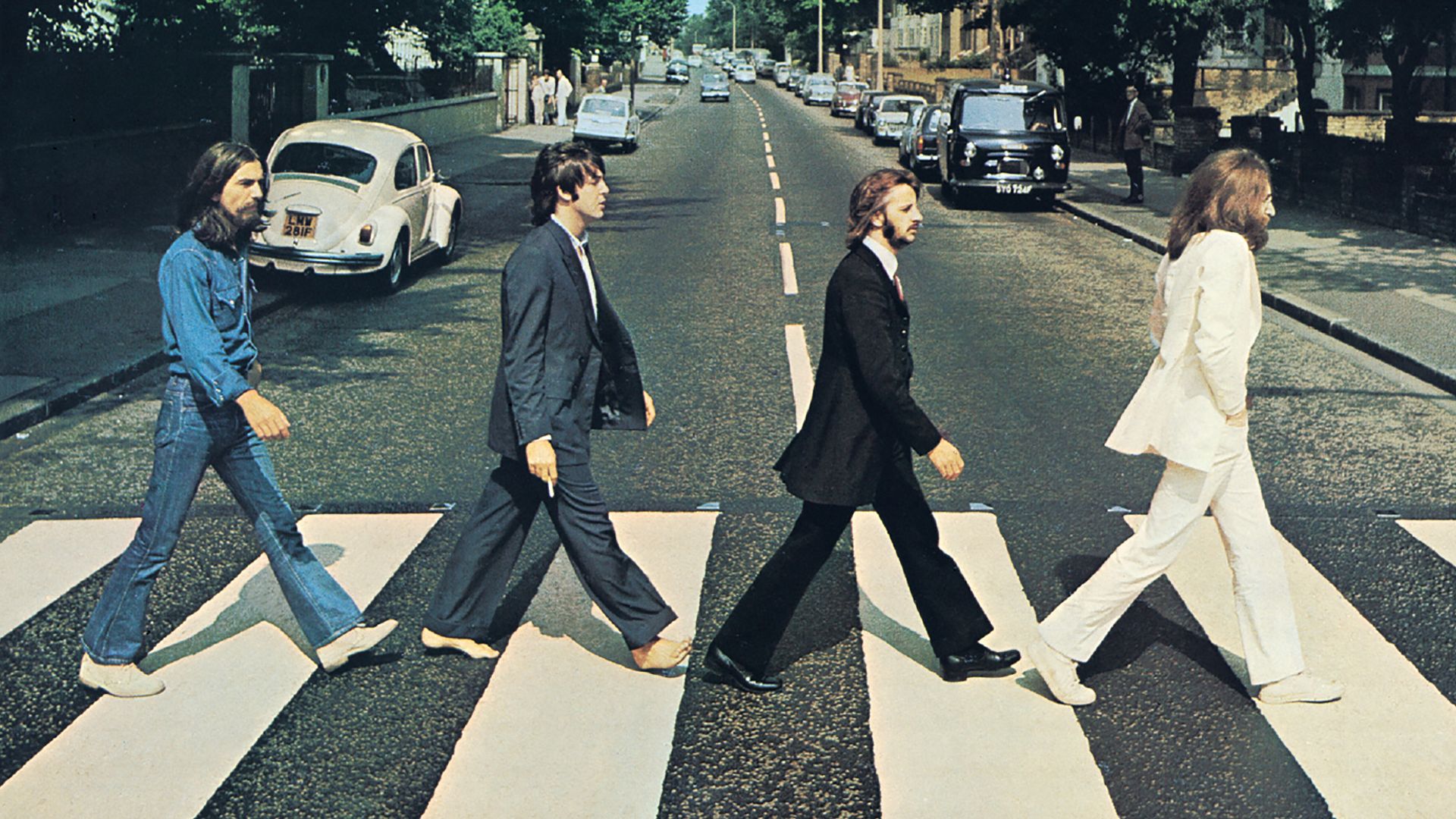 Front cover of Abbey Road by The Beatles. The view really is Abbey Road, London, NW8 looking north.  The gates of the Abbey Road Studios are behind the white VW Beetle on the left.