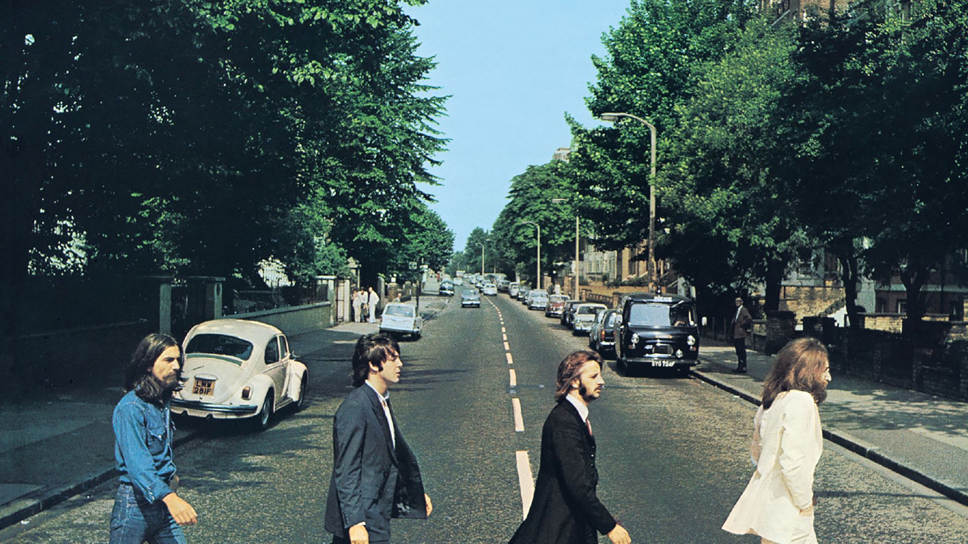 Front cover of Abbey Road by The Beatles. The view really is Abbey Road, London, NW8 looking north.  The gates of the Abbey Road Studios are behind the white VW Beetle on the left.